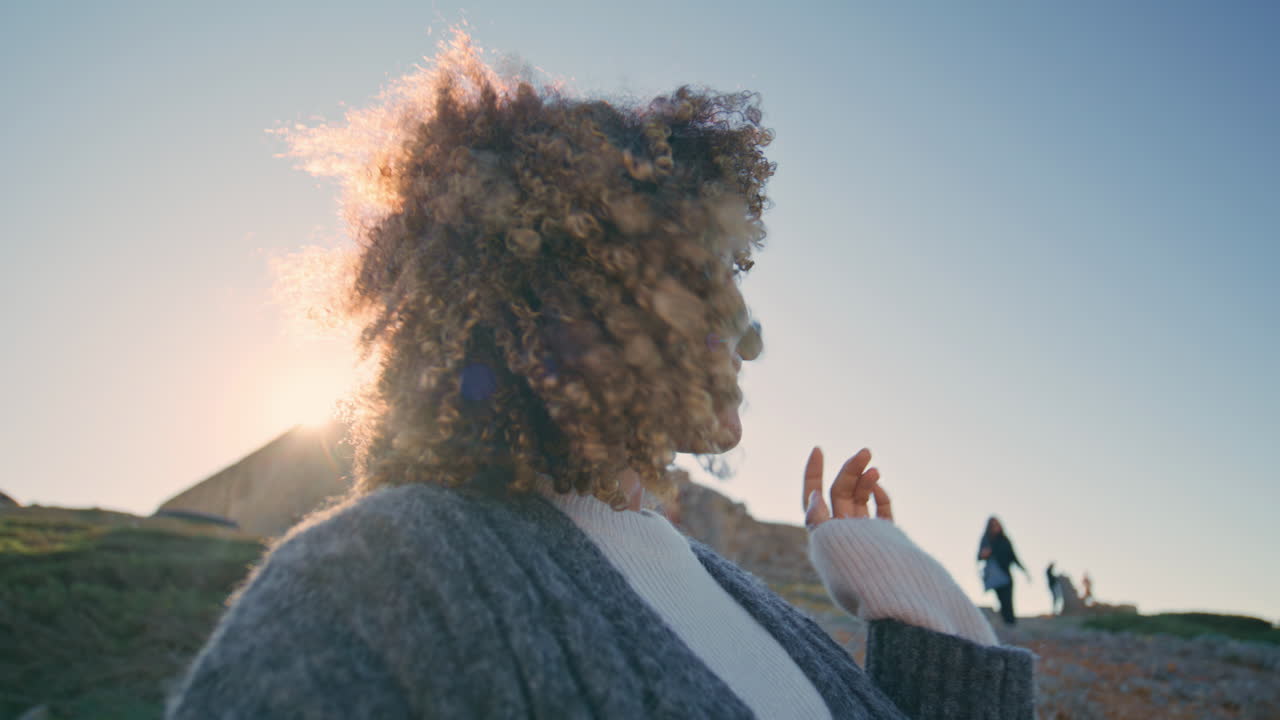 Smiling woman recording blog at sunset closeup. Blogger looking camera talking