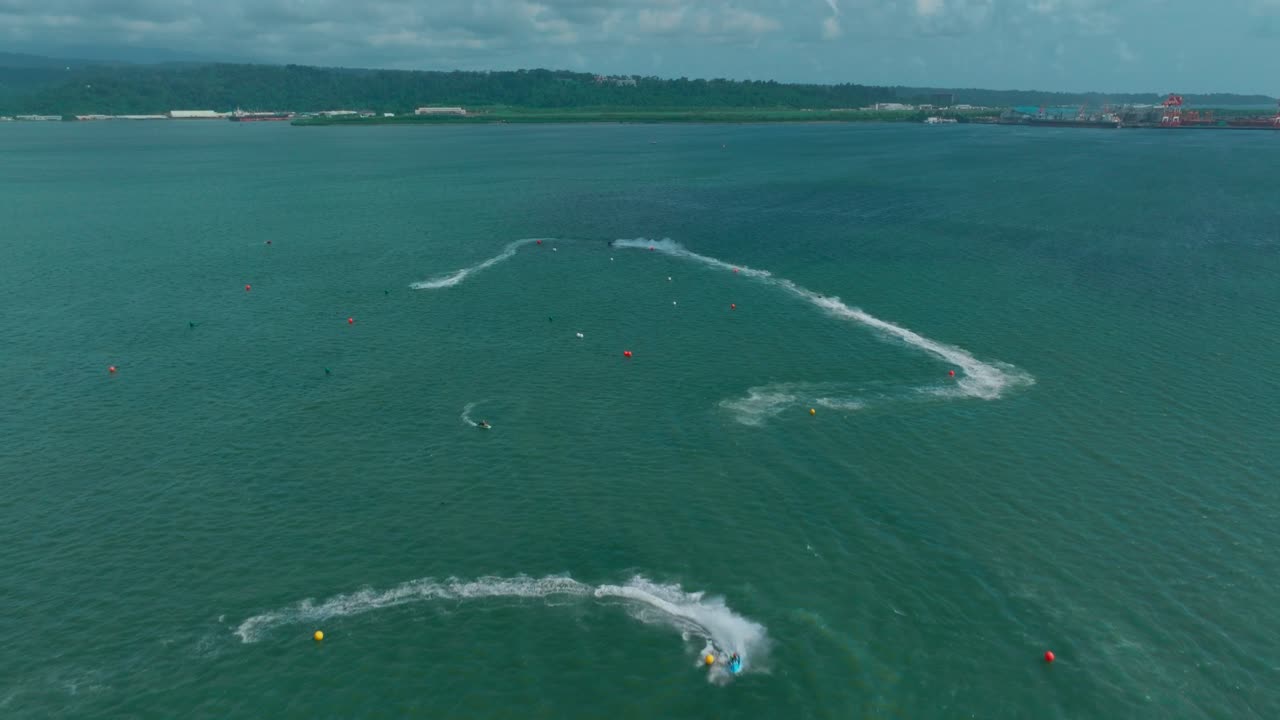 A wide drone shot showcases the vast Subic ocean, highlighting the exciting jet ski course carved into the shimmering blue waters.