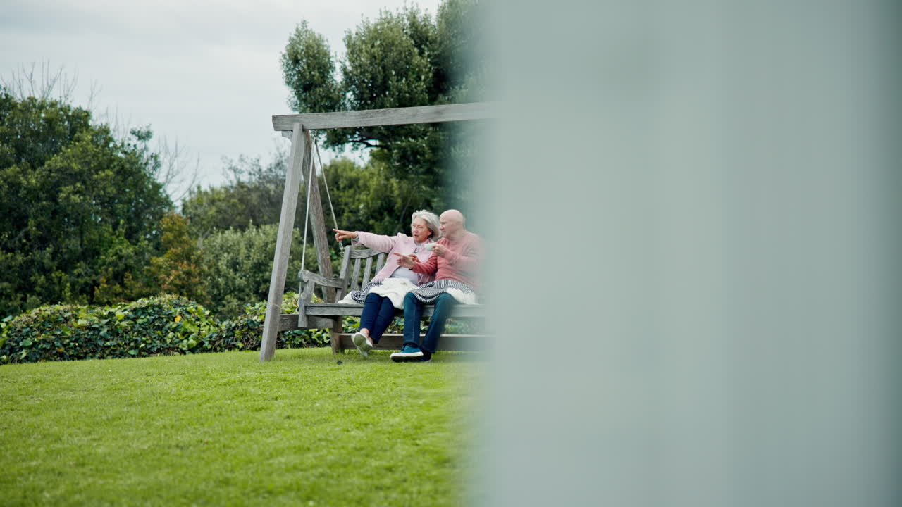 Senior couple on swing in garden with love