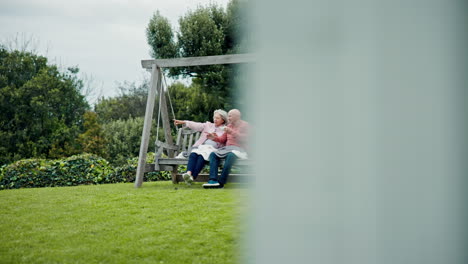 Senior-couple-on-swing-in-garden-with-love