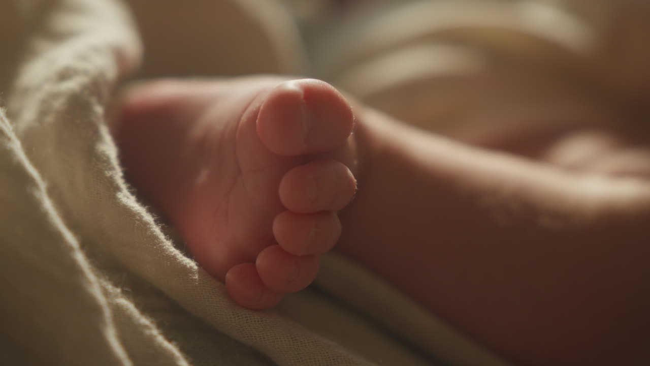 Close-up of newborn baby foot with soft lighting