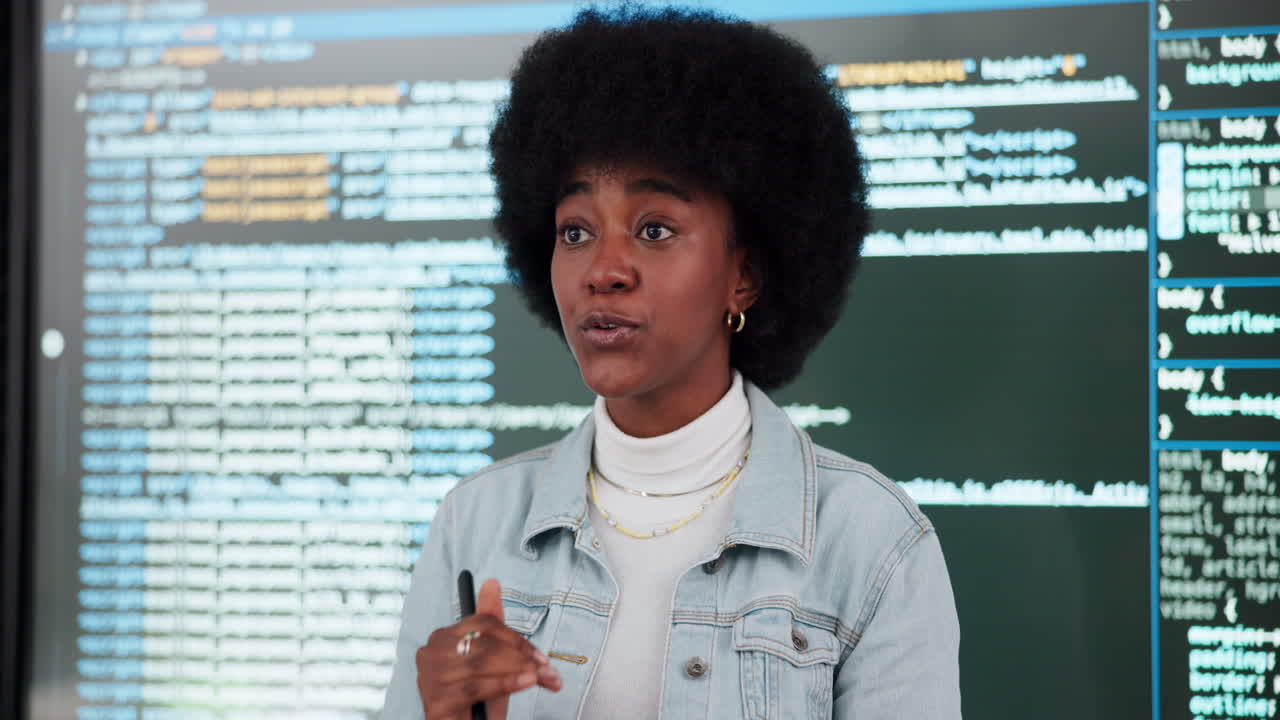 A woman is explaining code