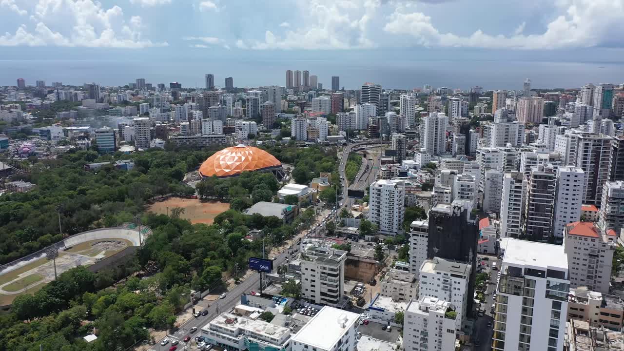 Drone view of the city of Santo Domingo on a sunny day, showing tall buildings and beautiful cityscapes