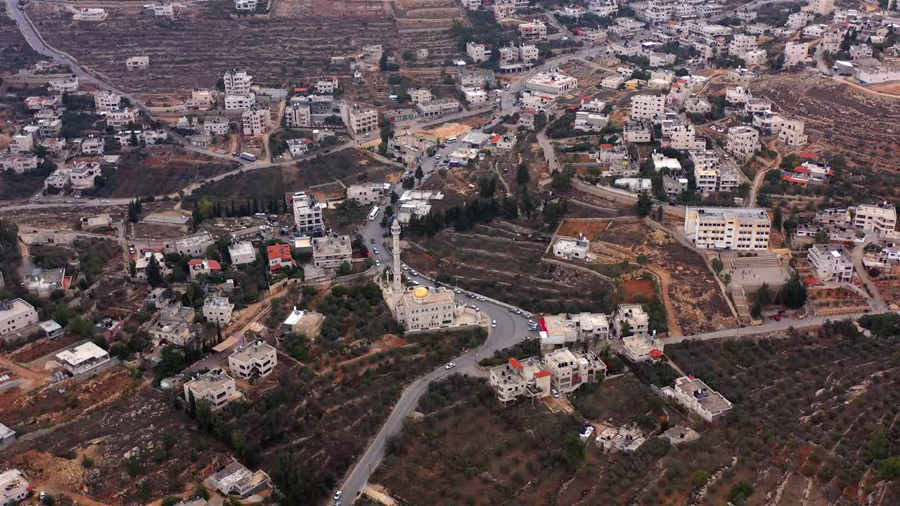 Aerial View of a Middle Eastern Town with a Mosque and Terraced Fields
