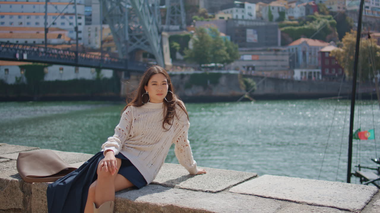 Dreamy woman relaxing sunny promenade alone. Romantic girl looking camera posing
