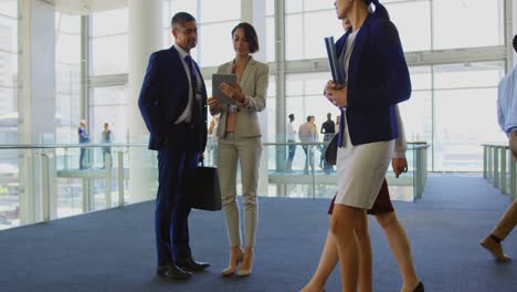 Business-people-discussing-over-digital-tablet-in-the-office-4k