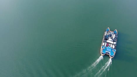 navrom ferry boat sailing across danube river carrying vehicles arriving at the port in galati city, romania