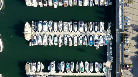 top down aerial shot of yachts and boats moored in a marina in california