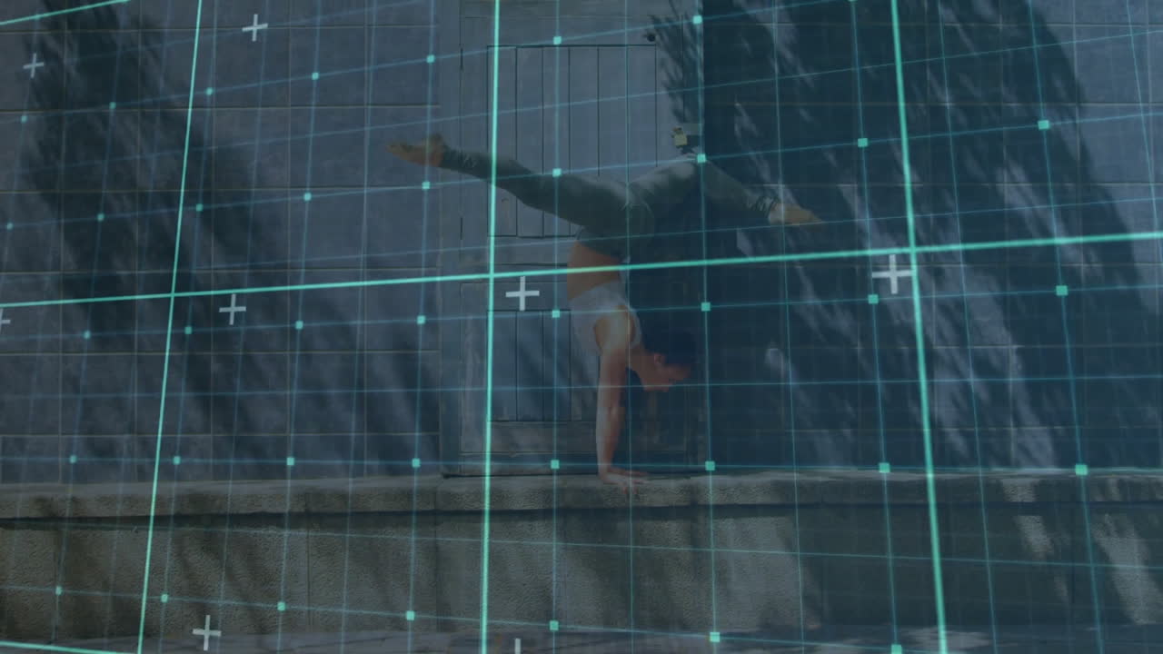 Woman performing handstand on concrete ledge in urban tech scene, showing teal grid overlay
