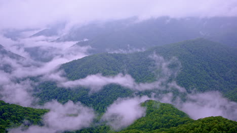 atmospheric sweep across misty smoky mountain crests