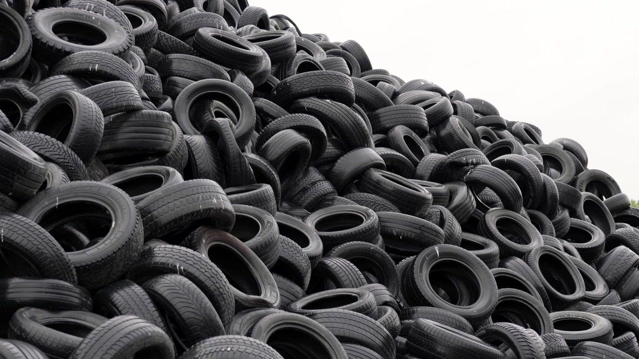 Pile of used rubber car tires in landfill