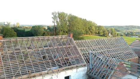 Rise-up-over-derelict-farm-buildings-to-reveal-scenic-green-valley