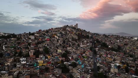 hill full of ghetto homes, dramatic evening in naucalpan, mexico city - aerial view