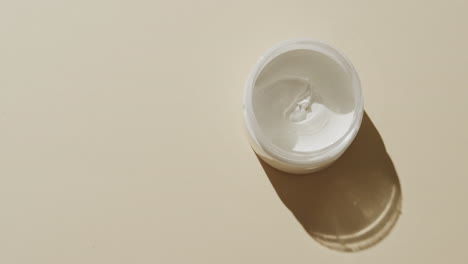high angle view of cream tub with copy space on white background