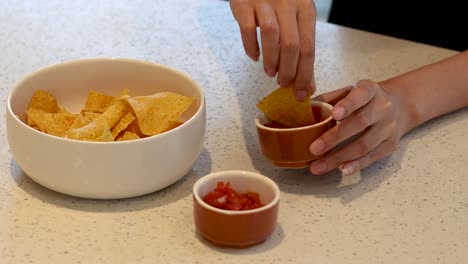 sequential dipping of a chip into salsa sauce.