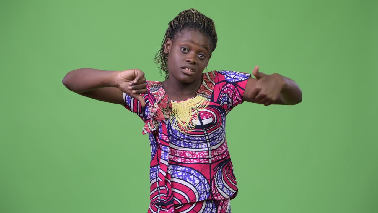 Young African woman choosing between thumbs up and thumbs down
