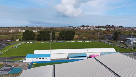 Low-flight-over-grandstand-at-sports-stadium-on-bright-sunny-day