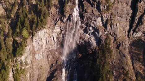 aerial drone footage pushing out at scenic fallbach in grindelwald, switzerland