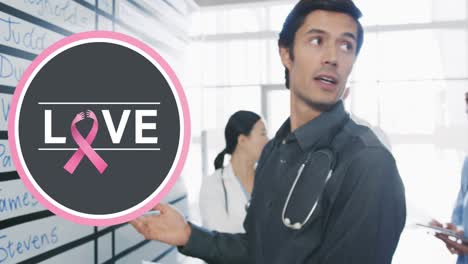 Animation-of-love-text-with-pink-ribbon-over-diverse-doctors-at-hospital