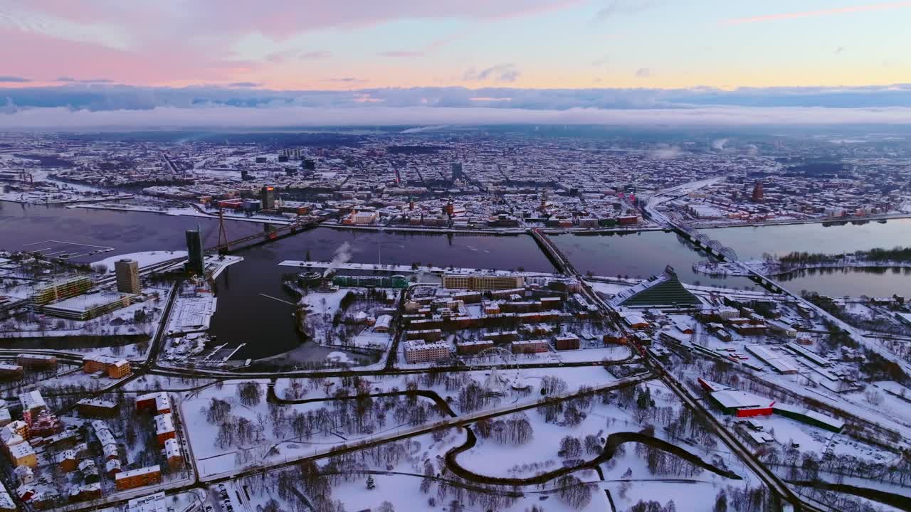 Cinematic establishing of snowy Riga skyline in Latvia during magical sunrise
