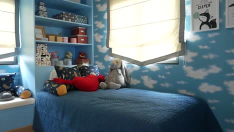 sky blue bedroom for little boy stuffed with toys and dolls