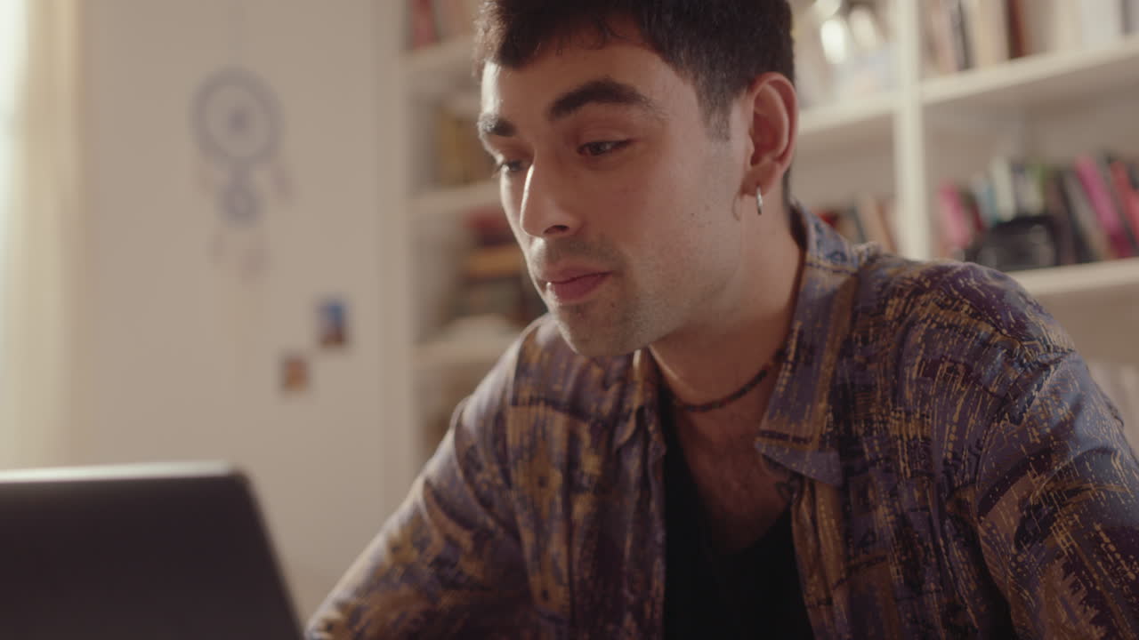 Young Man Having Conversation on Web Call on Laptop at Home