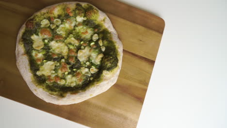 delicious homemade italian pizza with a sourdough crust ready to be sliced and enjoyed by the whole family being taken off the table to be served leaving space for text on a pure white background