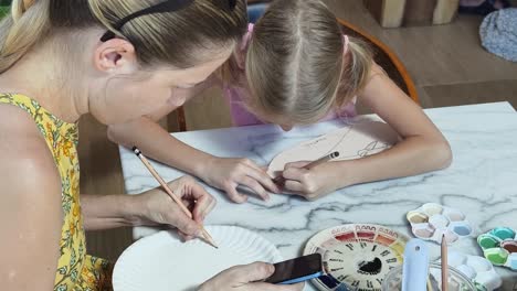 mother and daughter doing art project