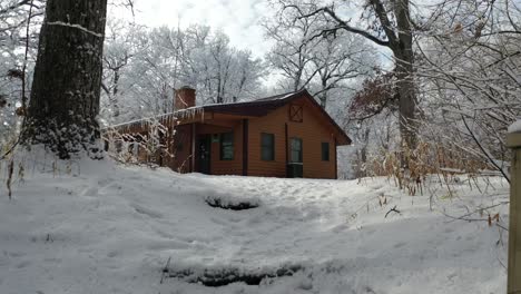 reveal idyllic american traditional cabin in winter forest, dolly