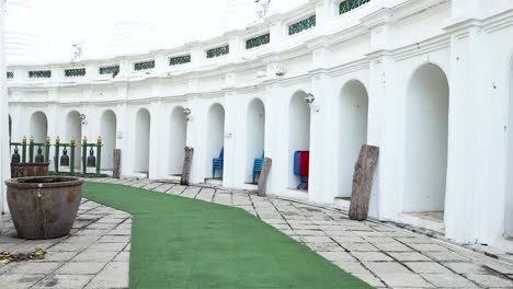 white circular temple exterior with bells and arches