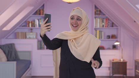 happy muslim woman clicking selfies