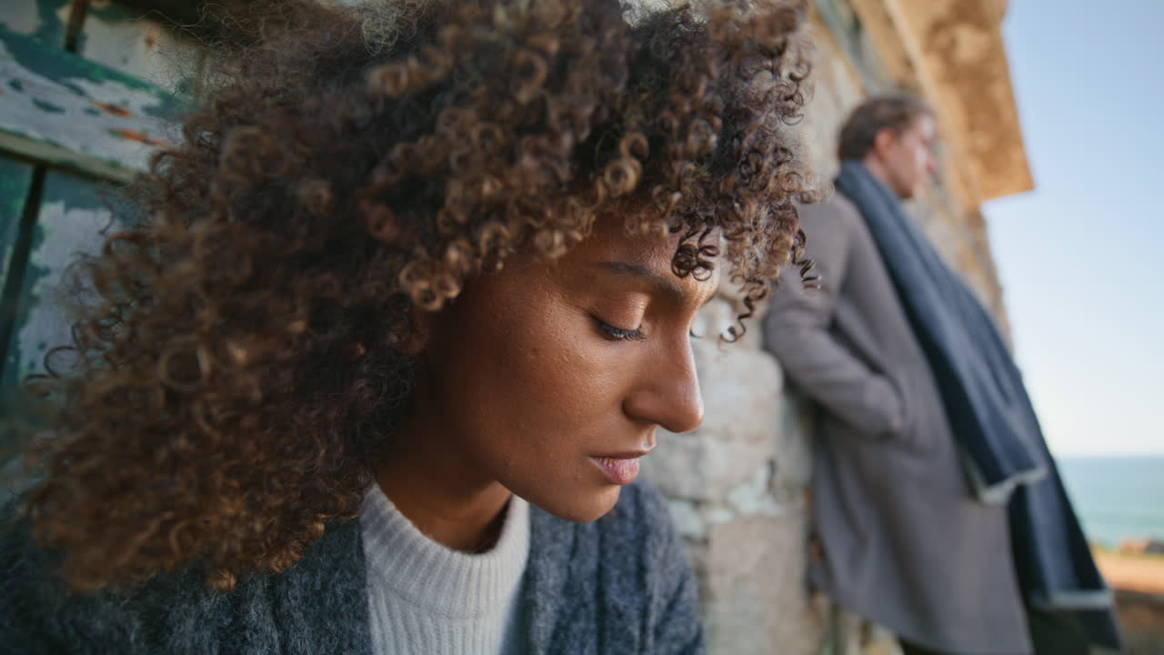 Upset woman thinking problems outdoor closeup. Curly model looking distance