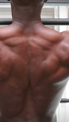 man doing pull ups at crossfit gym