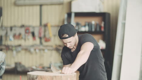 carpenter cutting wood with handsaw in workshop 8