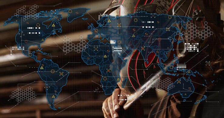Welder lifting helmet to inspect weld, activating industrial world map overlay with lit data nodes