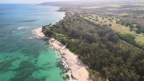 aerial-view-following-the-coastline-of-police-beach-on-oahu-hawaii