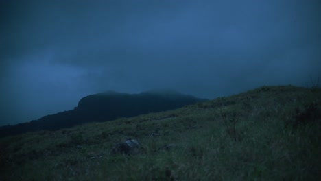 dark clouds move over a mountain in the distance