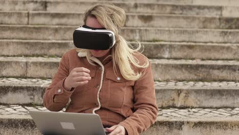Slow-motion-shot-of-young-woman-with-VR-glasses-and-laptop