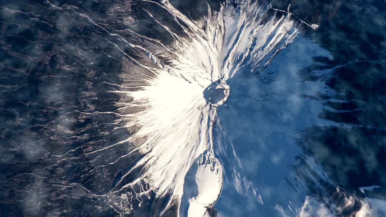 Flying over the earth on the ISS. Flying over the snow-capped mountains, aerial view from space.