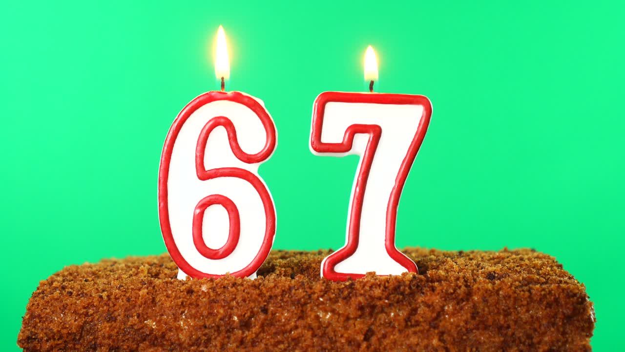 Cake with the number 67 lighted candle. Chroma key. Green Screen. Isolated