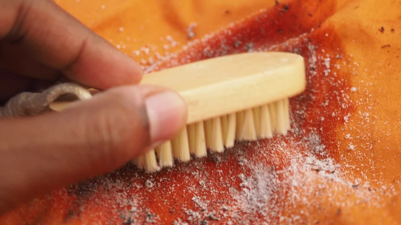 Cleaning fabric with a brush