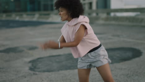 dancing woman young mixed race dancer performing urban style street dance in city practicing freestyle moves trendy female with afro