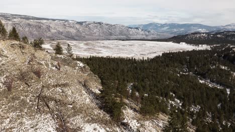 traverse through a winter oasis: barnhartvale road in kamloops amid a scenic hilly landscape