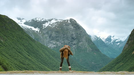 happy woman dancing in norwegian mountains