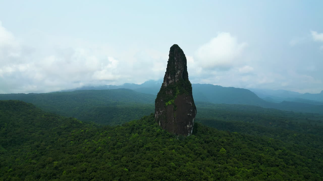 Aerial view orbiting the Pico Cao Grande needle peak in Sao Tome and Principe