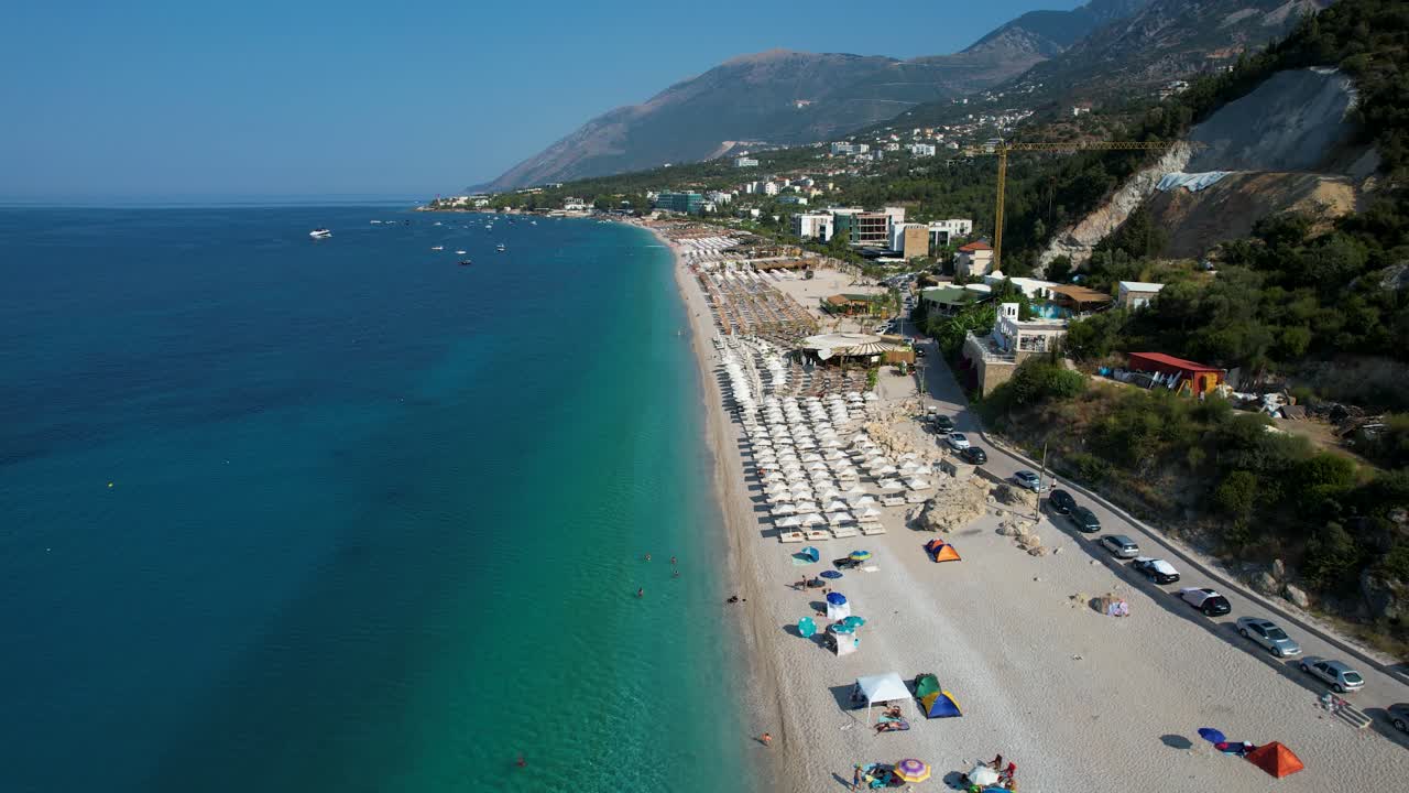 Beautiful Bay of the Ionian Sea with Turquoise Waters and White Sand Beach Filled with Sun Umbrellas in Dhermi
