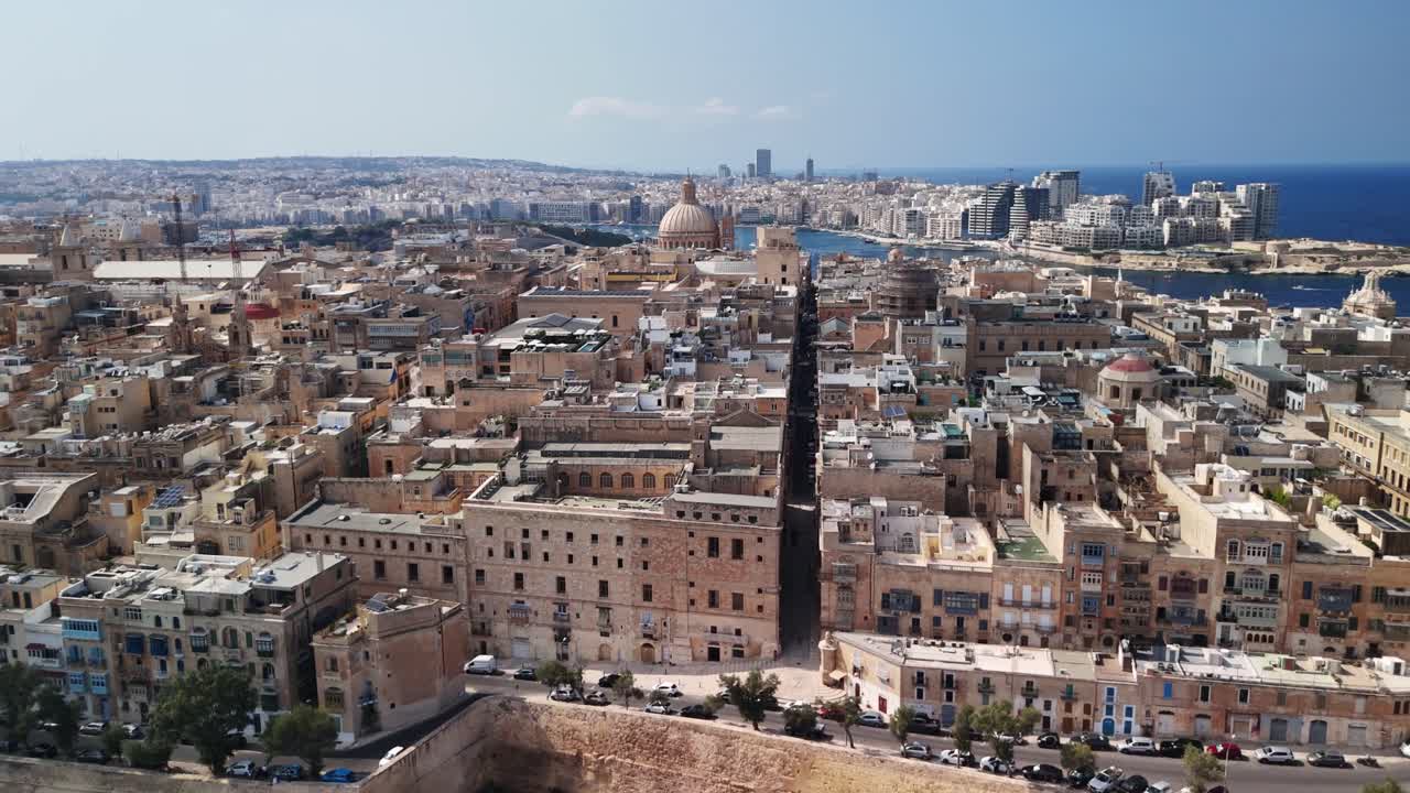 Aerial view of Malta's historic cityscape under a clear blue sky