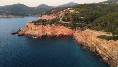 aerial landscape shot of the coast at punta galera in ibiza, spain during sunset