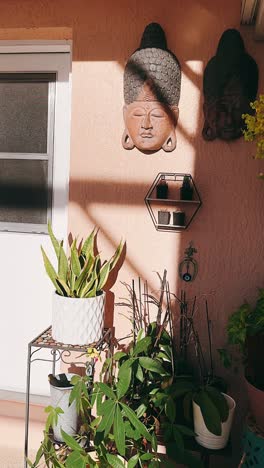 outdoor patio decor with plants and buddha heads