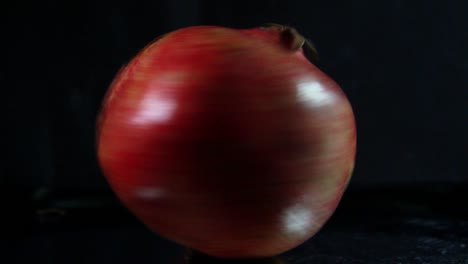 pomegranate in fast rotation on black background-1